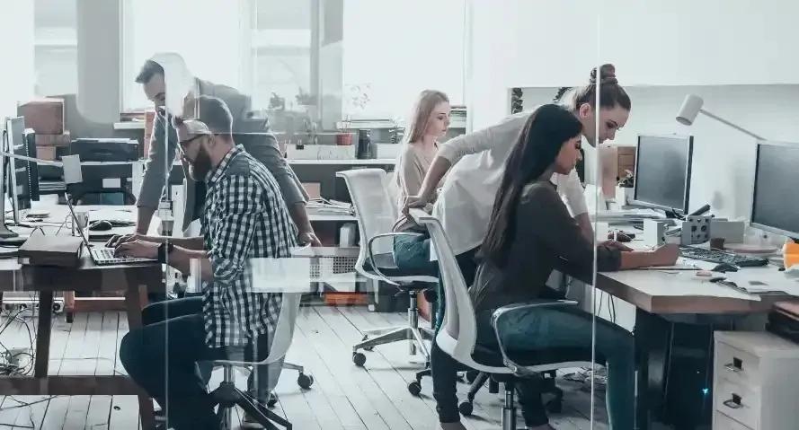 Supportive HR team in a busy office using HR analytics for employee insights